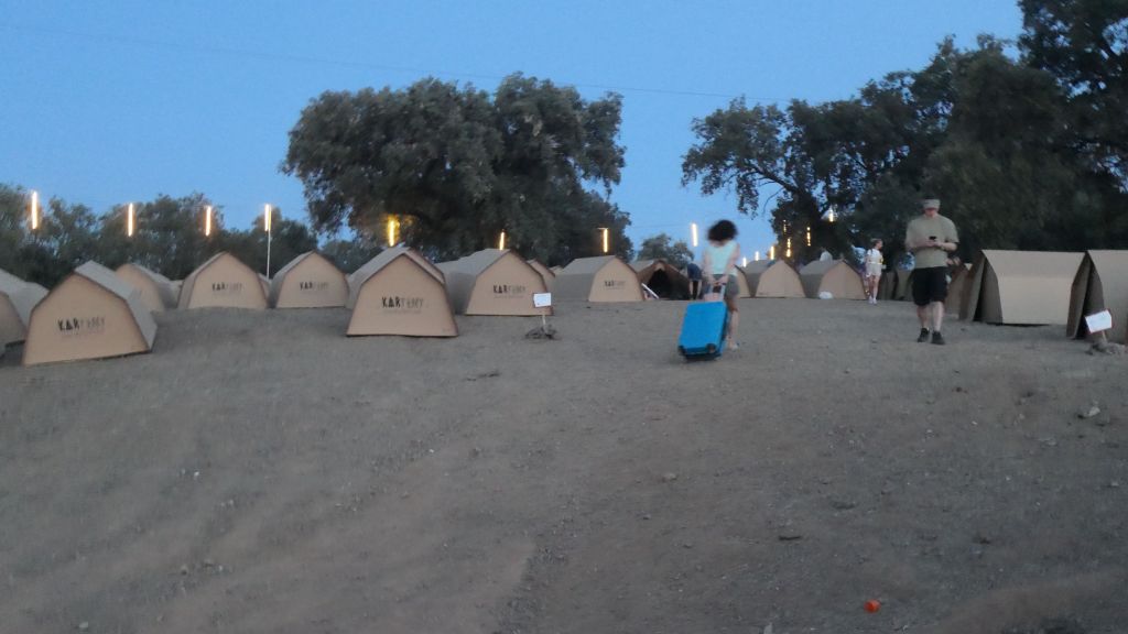 the path to cardboard village is steep, even without luggage