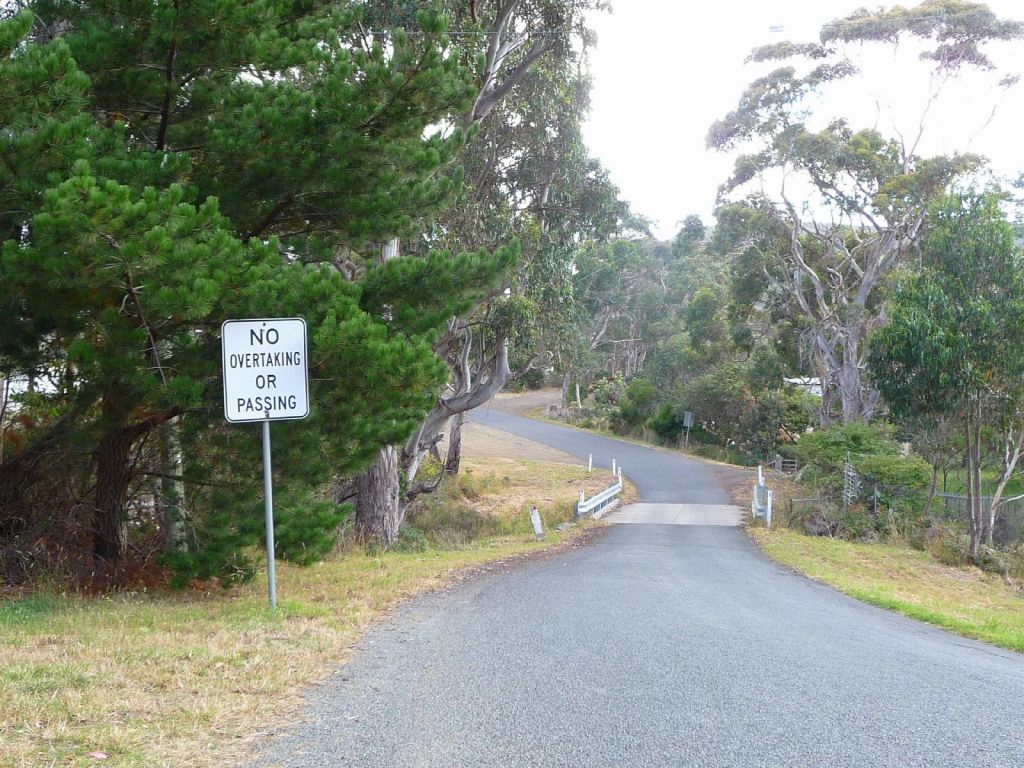 I love this sign, the bridge is only wide enough for one car, you can't pass anyway